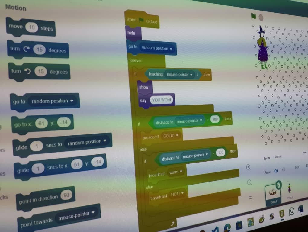 Kids working together on a coding challenge