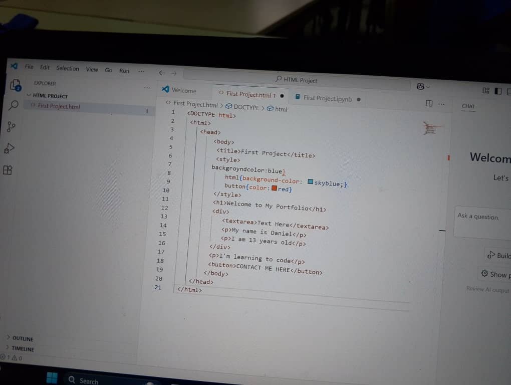 Kids typing HTML code on a laptop